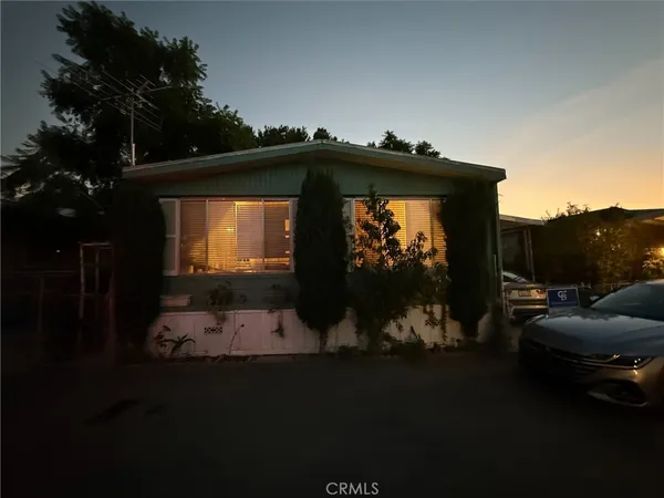 a back yard of the house with a swing chair
