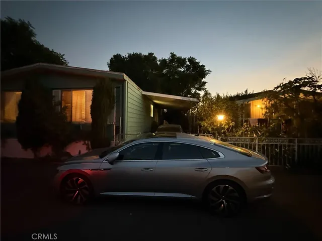 a front view of a house with parking space