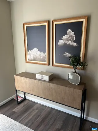 a living room with furniture and a painting on the wall