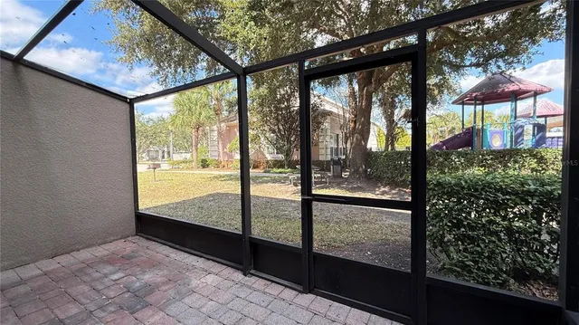 a view of a room with a large window and front door