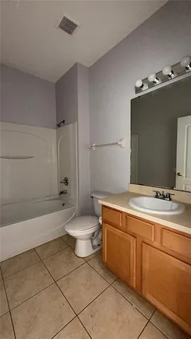 a bathroom with a sink a toilet and bathtub