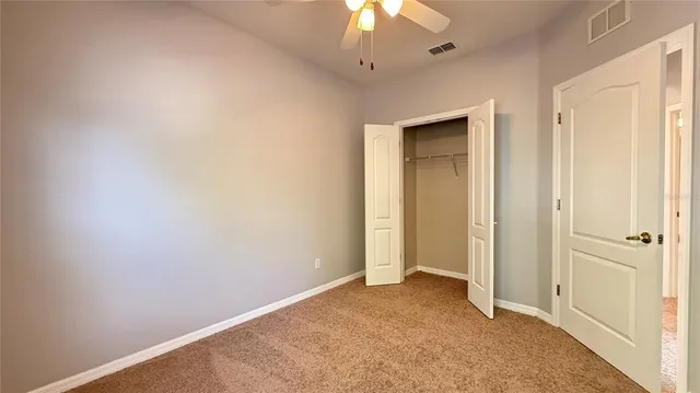 an empty room with a ceiling fan