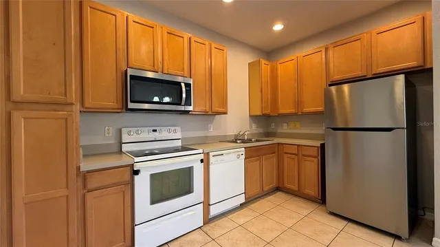 a kitchen with a refrigerator sink and microwave