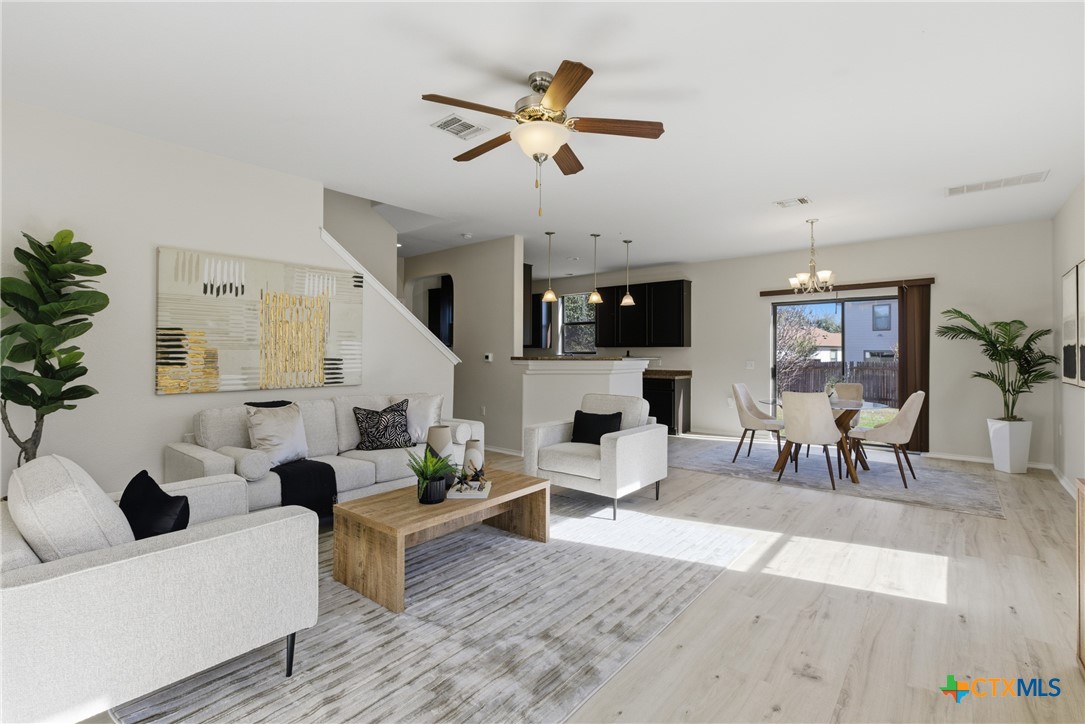 a living room with furniture and kitchen view