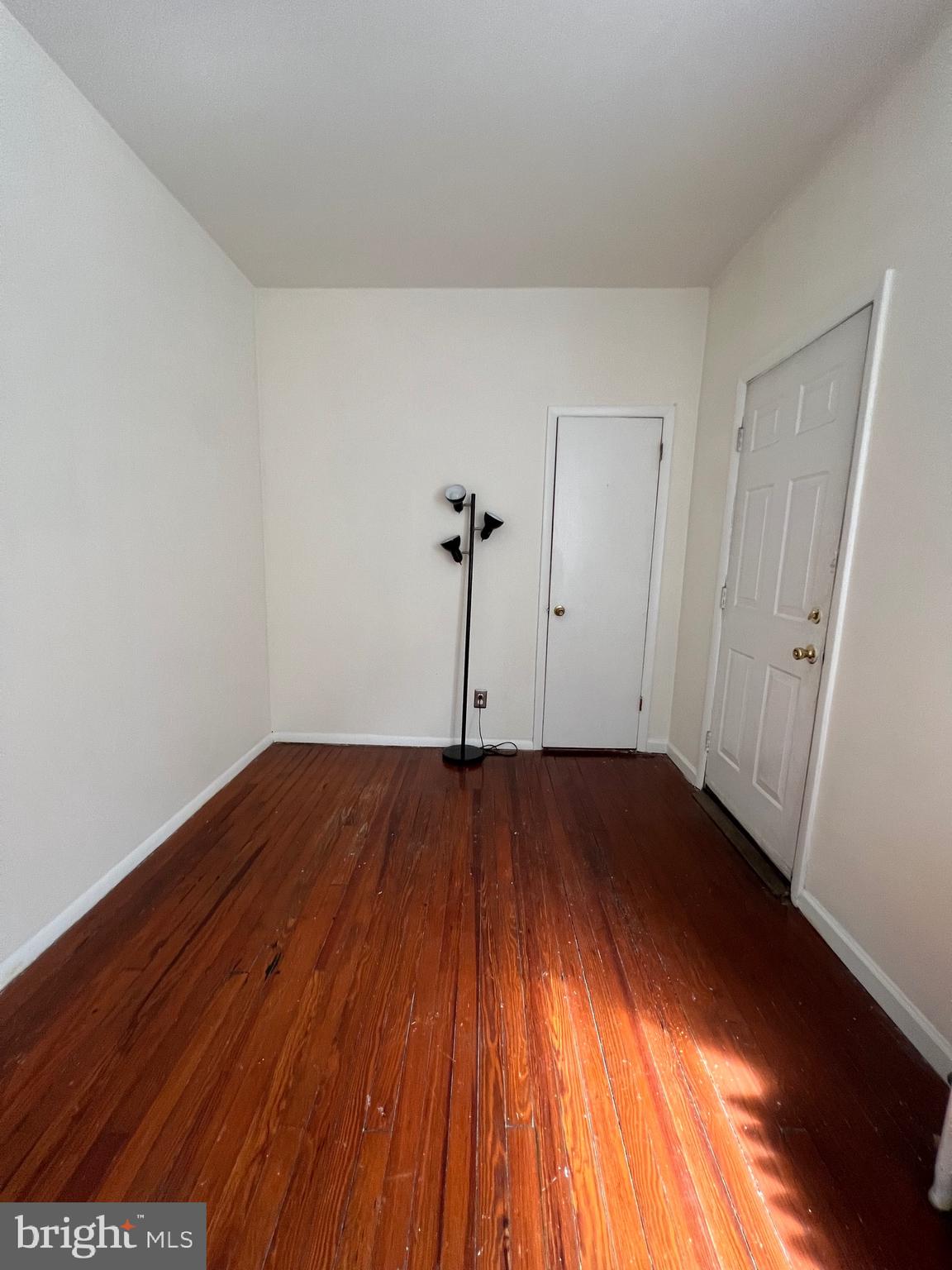 721 Bainbridge Street, Unit 2 Philadelphia, PA 19147 - Photo 4 of 8 a view of a room with wooden floor and white walls