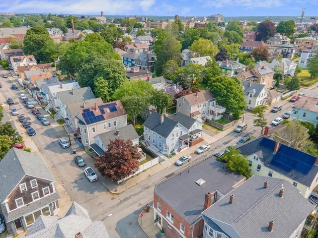 an aerial view of a house with a yard