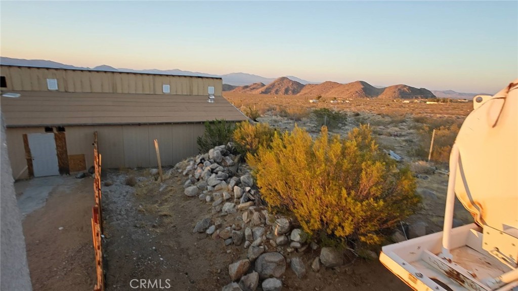 31576 Emerald Road Lucerne Valley, CA 92356 - Photo 9 of 51 a view of a house with a yard