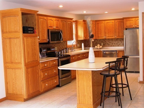 185 Athol Road Phillipston, MA 01331 - Photo 6 of 29 a kitchen with stainless steel appliances kitchen island granite countertop a stove a sink a refrigerator and chairs with wooden floor