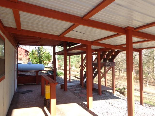 2434 Toler Road Woodlawn, TN 37191 - Photo 6 of 20 Aggregate pad, perfect area for a hot tub. under deck has tin roof so that it makes for an additional sitting area on those rainy days. Propane tank conveys currently with 50% propane.