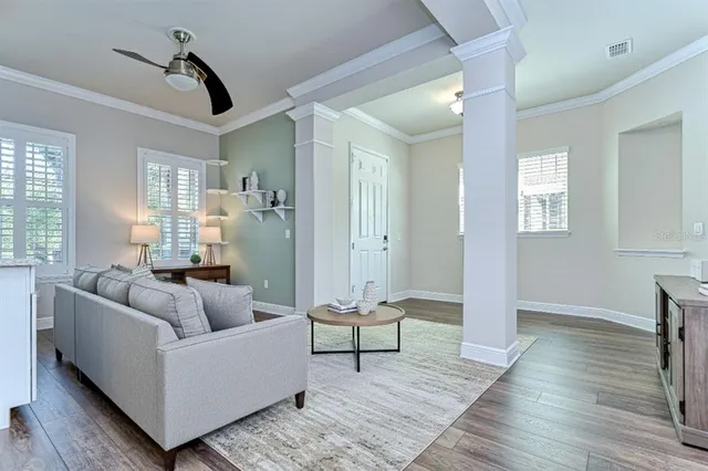 a living room with furniture and a wooden floor