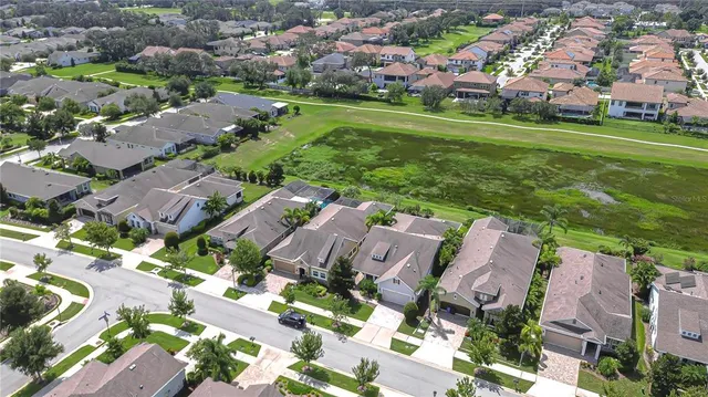 an aerial view of residential houses with outdoor space and street view