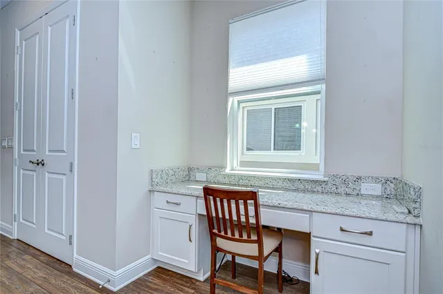a bathroom with a granite countertop sink a mirror and a vanity