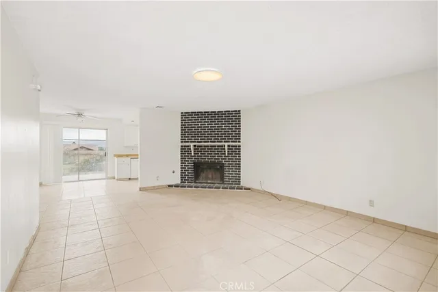 a view of an empty room with a fireplace