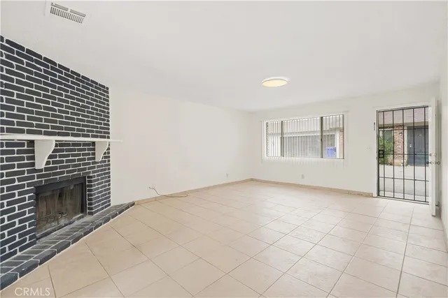 a view of an empty room with a fireplace