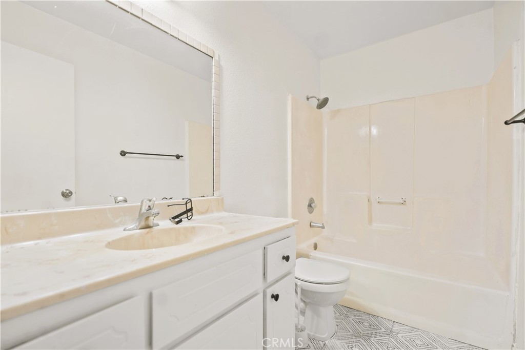 20209 Otoe Road Apple Valley, CA 92307 - Photo 26 of 32 a bathroom with a sink a toilet and shower