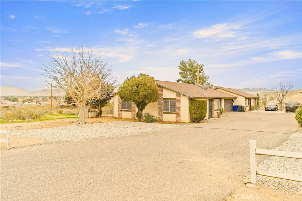 20209 Otoe Road Apple Valley, CA 92307 - Photo 7 of 32 a front view of a building with a road