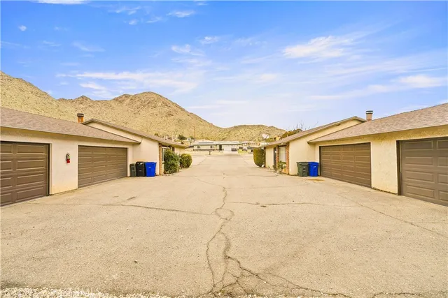 a view of a house with potted plants