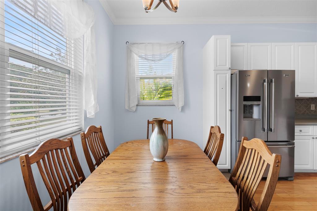 11 Winghaven Lane Fort Pierce, FL 34949 - Photo 14 of 50 a view of a dining room with furniture window and wooden floor