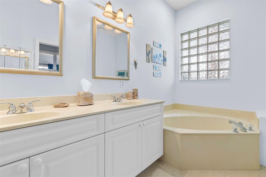 11 Winghaven Lane Fort Pierce, FL 34949 - Photo 18 of 50 a bathroom with a tub a sink and mirror