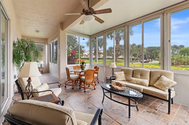 a living room with furniture and a floor to ceiling window