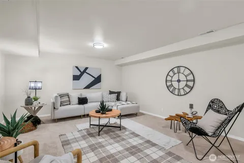 a living room with furniture and a dining table with potted plants