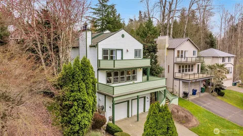 a front view of a house with yard and green space