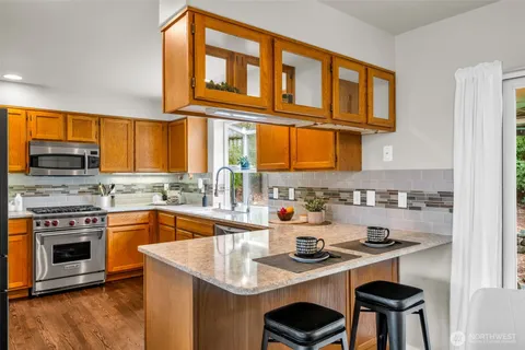 a kitchen with a stove a sink and cabinets