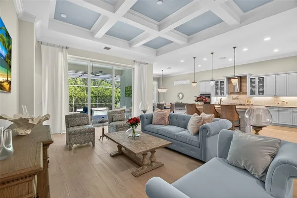 a living room with furniture wooden floor and a large window