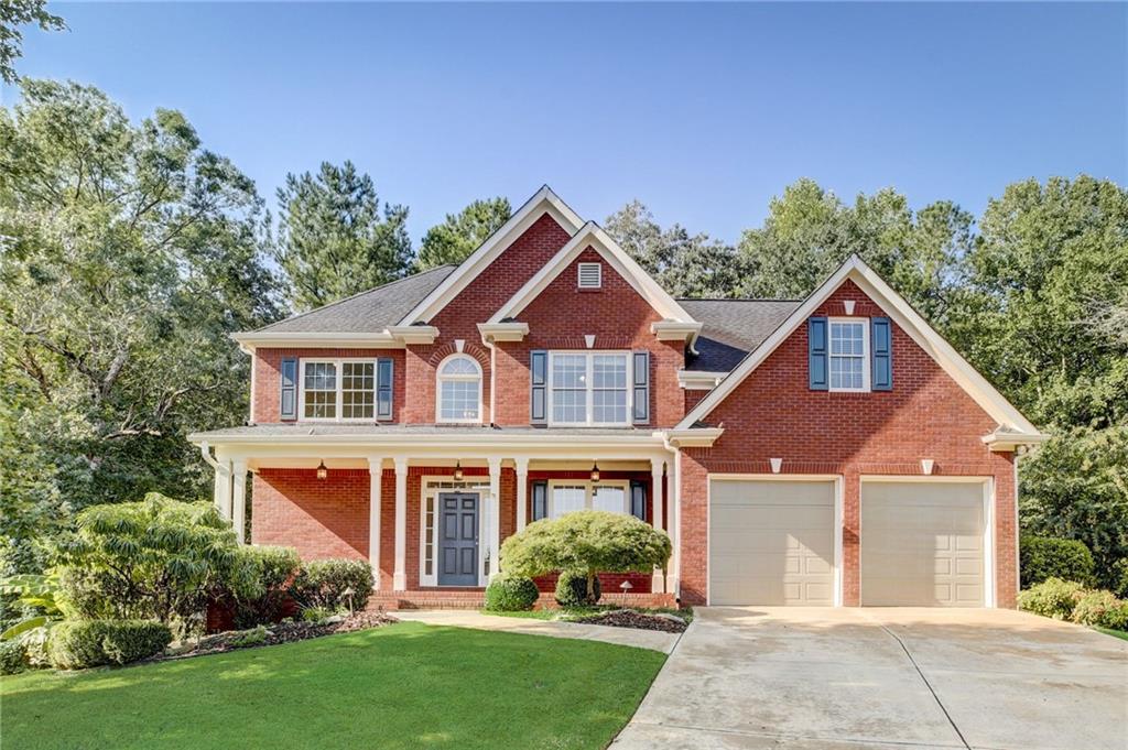 front view of brick house with a yard