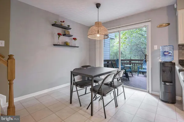 a dining room with furniture a chandelier and window