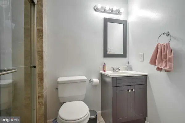 a bathroom with a toilet a sink and mirror