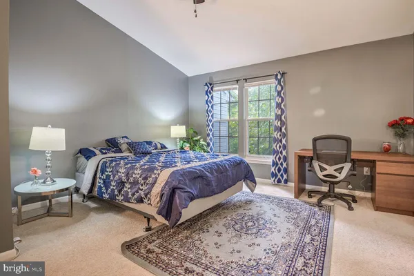 a bedroom with bed and a window