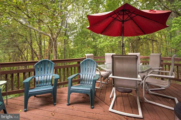 a view of backyard with seating space and wooden floor