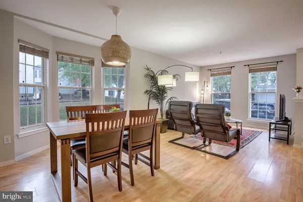 a dining room with furniture window and wooden floor