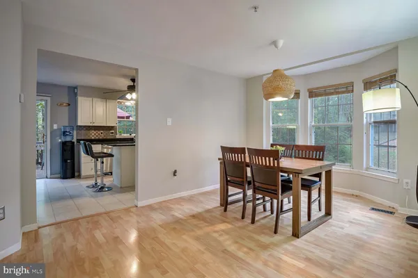 a dining room with furniture and wooden floor