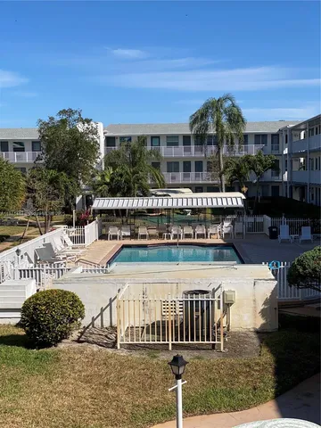 a view of a backyard with plants and outdoor seating