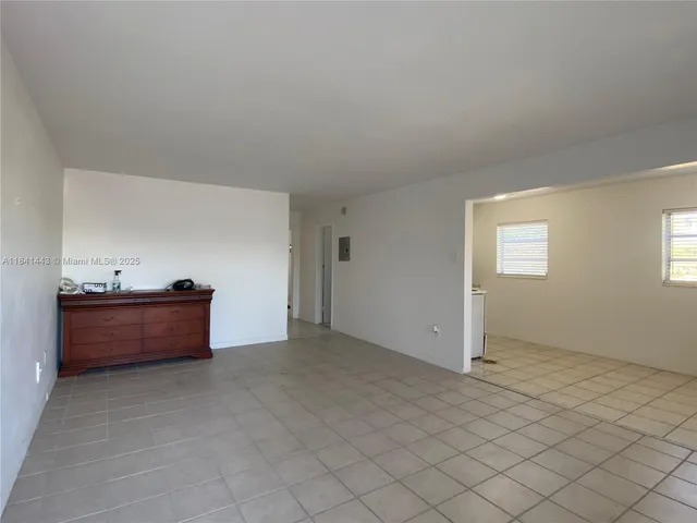 a kitchen with a stove sink and cabinets