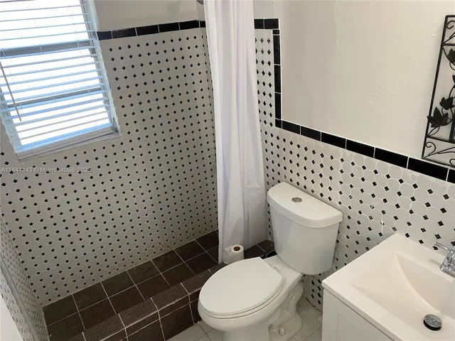 a view of a building with floor to ceiling windows and a swimming pool