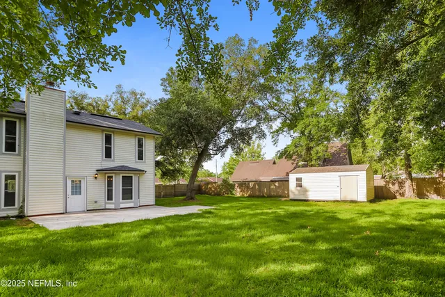 a front view of house with yard and trees