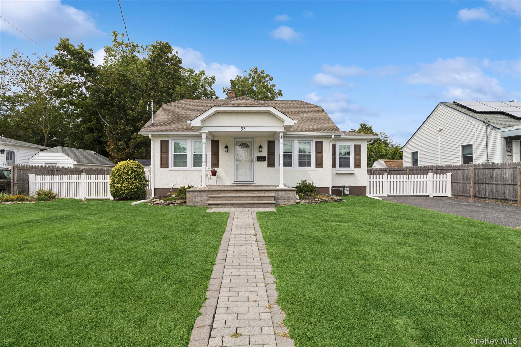 33 Schroeder Lane Patchogue, NY 11772 - Photo 1 of 1 a front view of a house with a garden