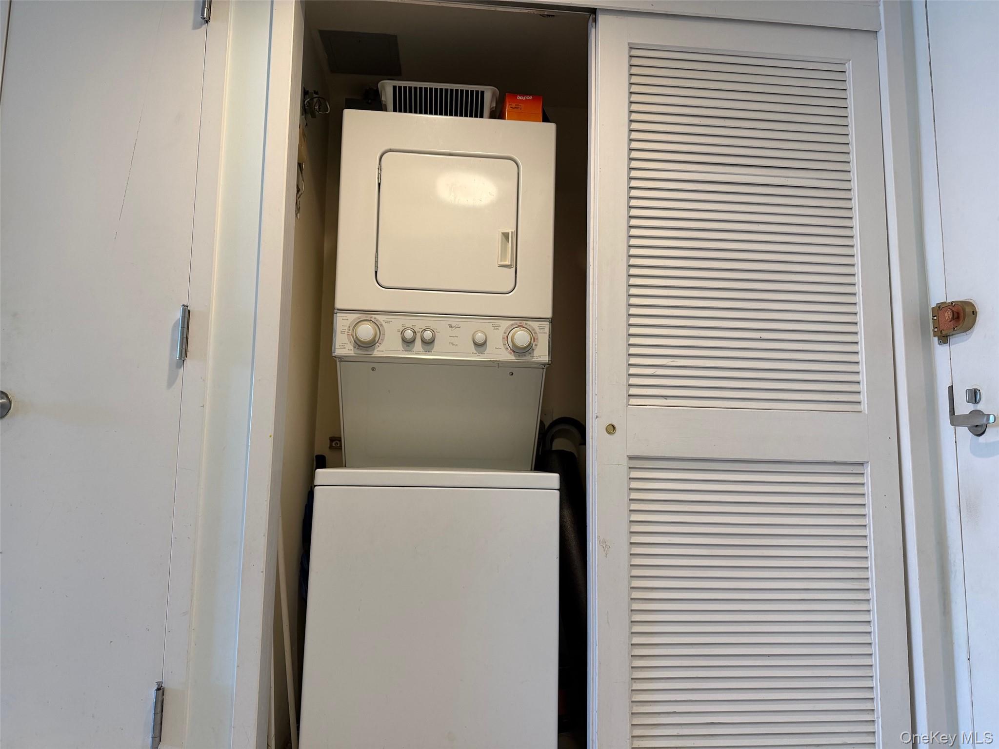 88 Cutter Mill Road, Unit 308 Great Neck, NY 11021 - Photo 14 of 15 Laundry area with stacked washer / drying machine