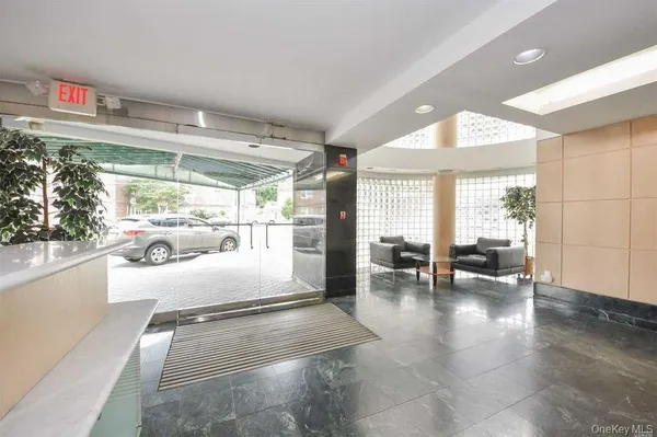 a lobby with furniture and floor to ceiling window