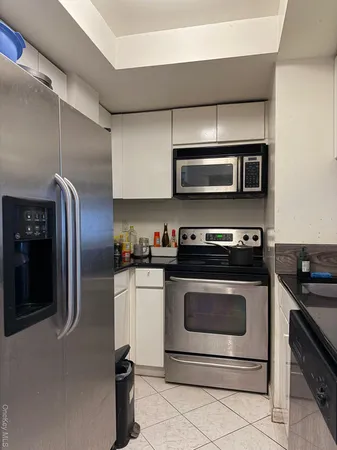 a kitchen with granite countertop a stove and a microwave