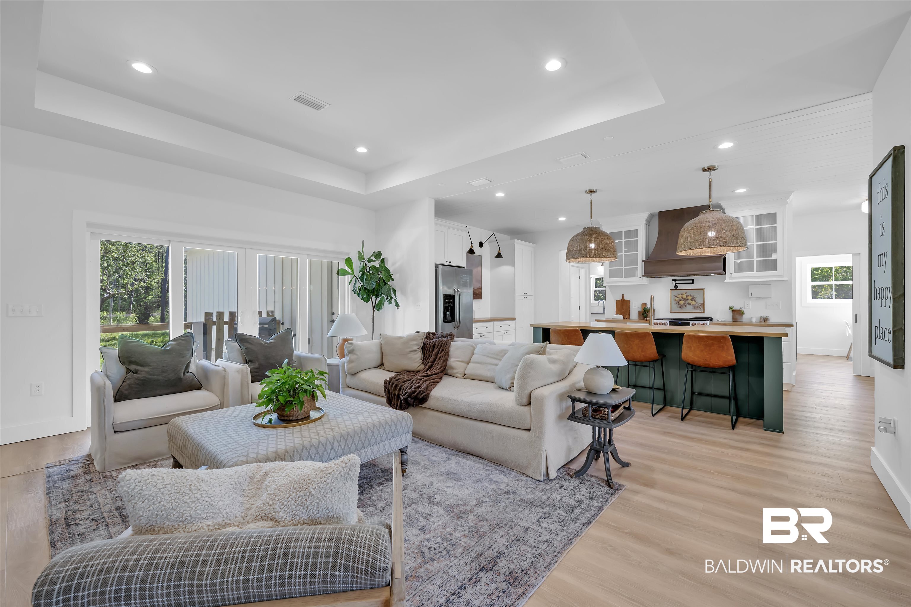 19058 James Road Gulf Shores, AL 36542 - Photo 10 of 49 Living room featuring a tray ceiling, light wood-style floors, and recessed lighting
