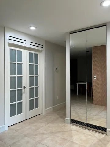 an empty room with windows and closet