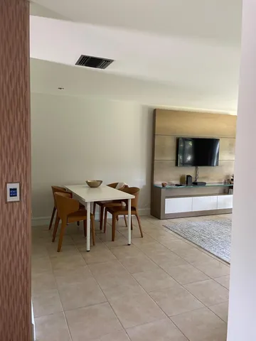 a view of dining room with furniture and a flat screen tv