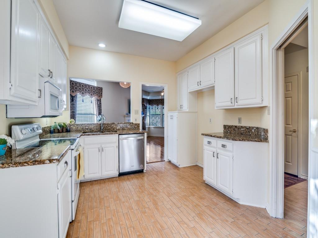 9981 Waterfront Trail Rowlett, TX 75087 - Photo 11 of 26 Kitchen featuring white electric range oven, white cabinets, dark stone counters, light wood-type flooring, and recessed lighting