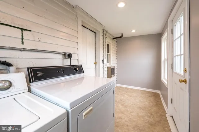 a view of washer and dryer with kitchen in the background
