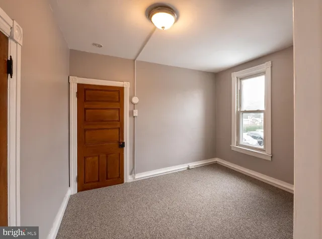 an empty room with windows and closet