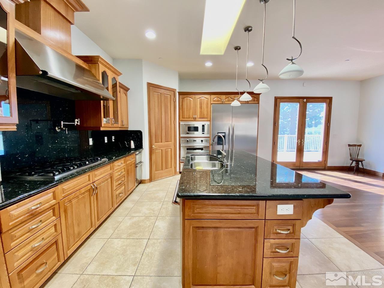 3807 Paradise View Carson City, NV 89703 - Photo 15 of 40 a large kitchen with granite countertop a sink and cabinets